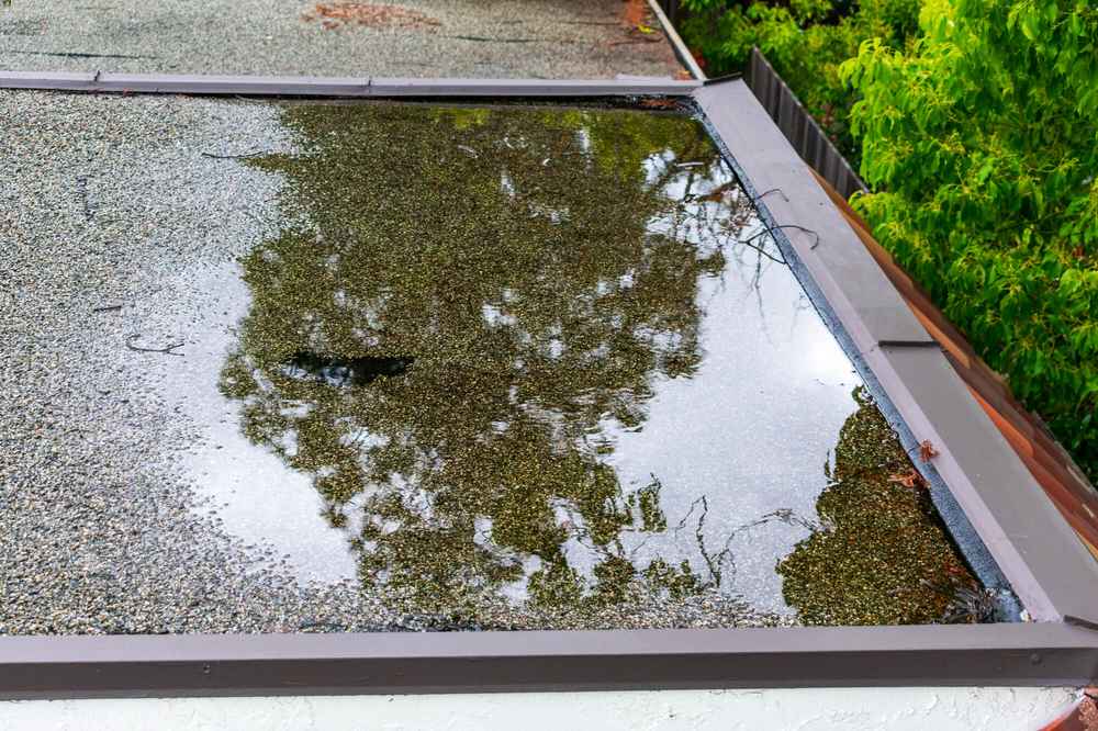 Standing water on a commercial roof in Westerly